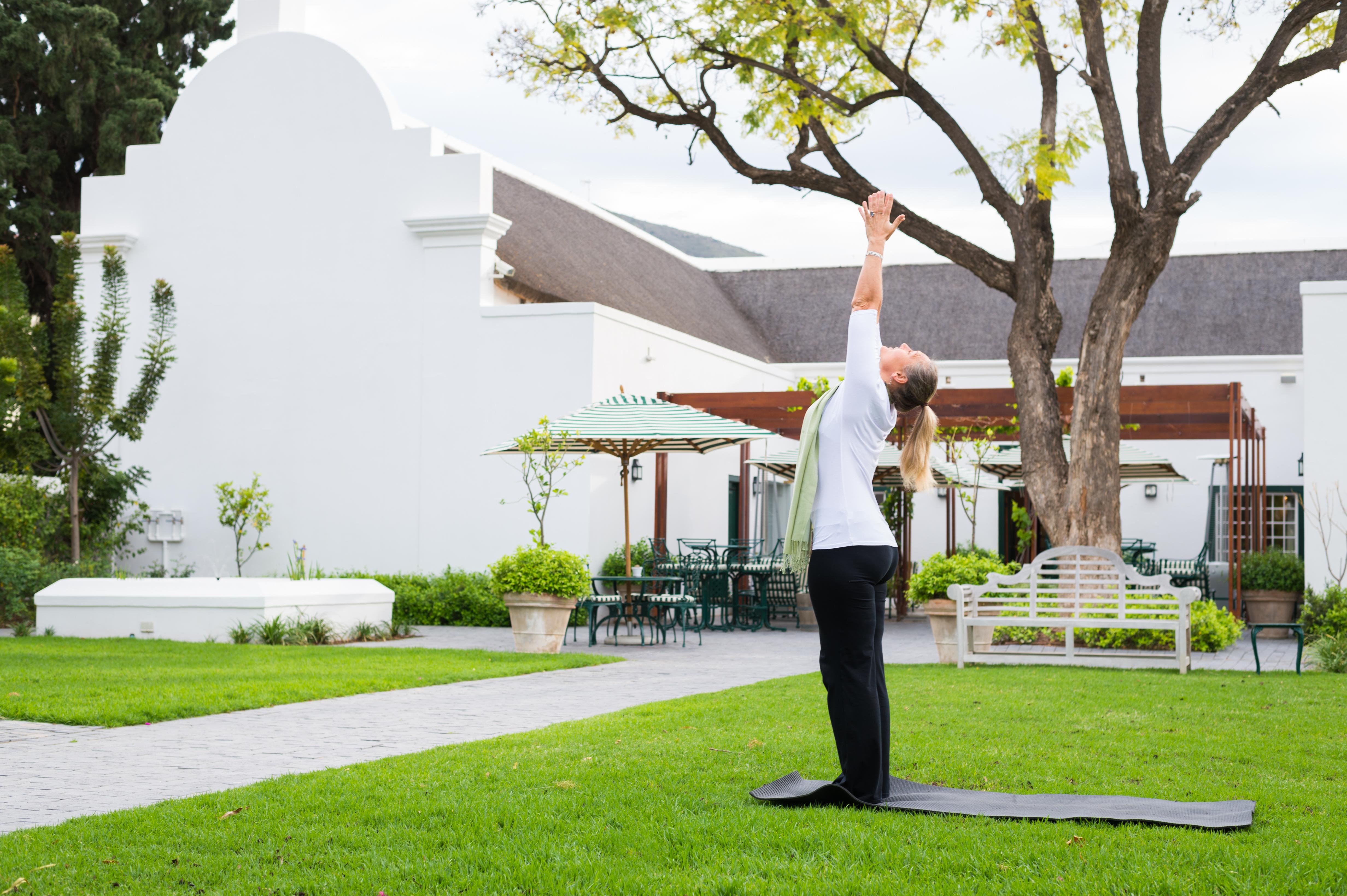 Drostdy Hotel Храфф-Рейнет Экстерьер фото A woman practicing yoga at the Cape of Good Hope